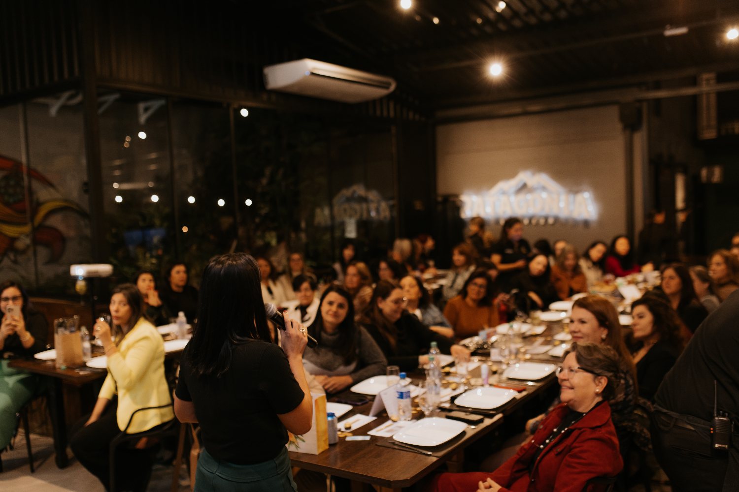 Ana Lígia Sena palestrando para uma plateia de mulheres em um evento